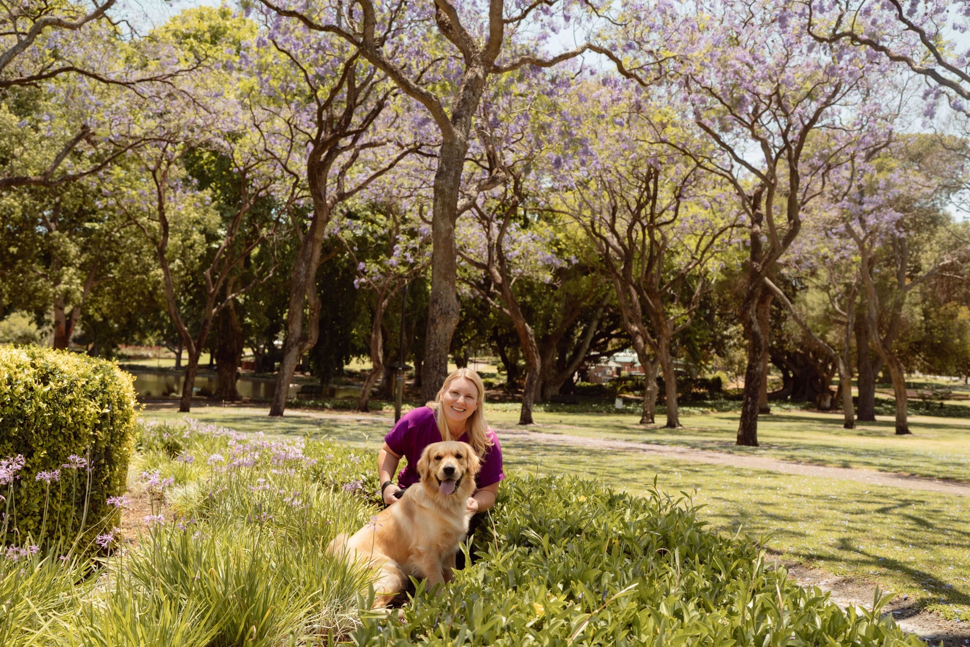 Britta with her dog in a flower bed — a deep soul connection